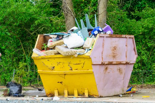Waste removal team handling builders rubbish from a flat