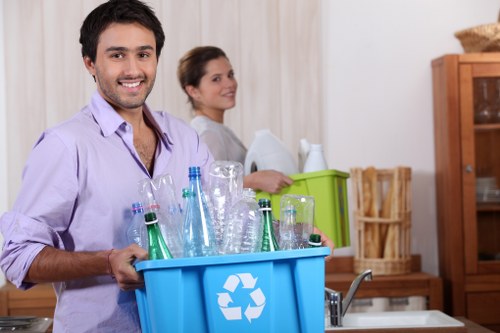 Recycling activity showing metals, cardboard, and wood prepared for recovery